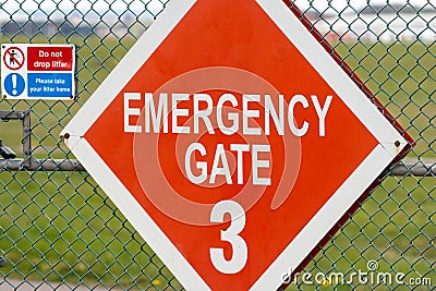 Emergency crash gate at airport runway red diamond warning sign. Gates number 3 information red and white words three. Stock Photo