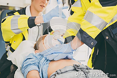 Emergency doctor giving cardiac massage for reanimation in ambulance Stock Photo