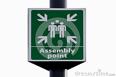 Emergency evacuation assembly point sign close up isolated against white background. Stock Photo