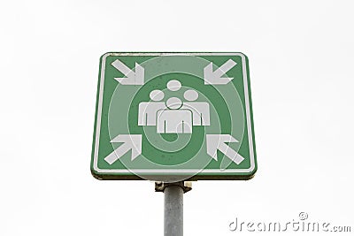 Emergency evacuation assembly point sign on a pole on a white background Stock Photo