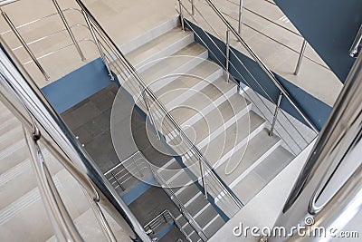 emergency and evacuation exit stairs in up ladder in new empty office building Stock Photo