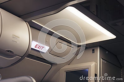 Emergency exit sign and toilet sign on airplane Editorial Stock Photo