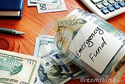 Emergency fund in glass jar with cash. Stock Photo