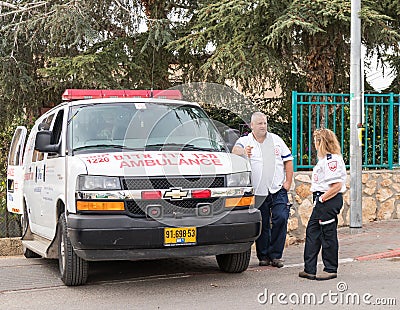 Emergency medical workers stand and talk in anticipation of the start `Cristmas Run` in Mi`ilya in Israel Editorial Stock Photo