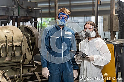 emergency pollution factory concept. Portrait engineer wearing a mechanical jumpsuit and gas mask looking at the camera with his Stock Photo