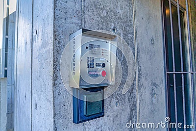 Emergency security box with call button mounted on the wall of campus building Stock Photo