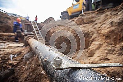 Workers of the repair team excavated pipeline Stock Photo