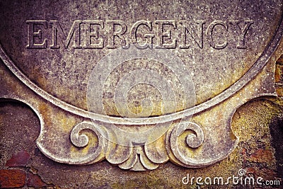 Emergency text written on stucco wall - concept image Stock Photo