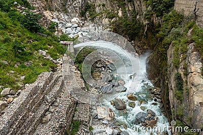 Emergency water outlet forcefully releasing into the river during the Himachal Pradesh monsoon in India Stock Photo