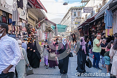 A lot of Turkish people with mask and tourists shopping and have dealings in one of the crowdest open air market place and trade Editorial Stock Photo