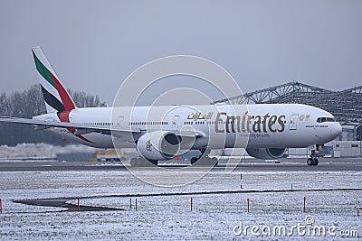 Emirates plane taxiing on Munich Airport, MUC, snow Editorial Stock Photo