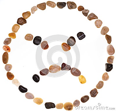 Emoji emoticon of very angry face handmade with stones boulders. Isolated on white background Collection made with stones Stock Photo