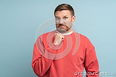 Emotion of disgust on face of young man. Guy looks at camera contemptuously with hostility, loathing Stock Photo
