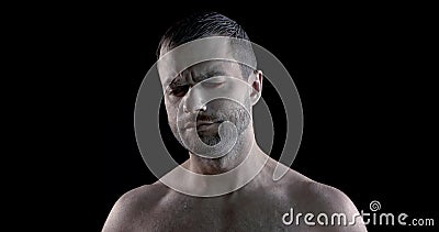 Emotional actor with white greasepaint on face is expression emotion in dark studio Stock Photo