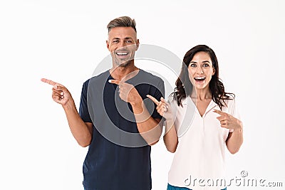 Emotional adult loving couple pointing isolated over white wall background Stock Photo