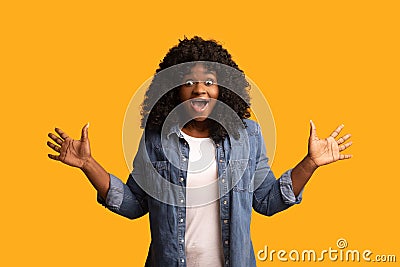 Emotional african american young woman on yellow Stock Photo