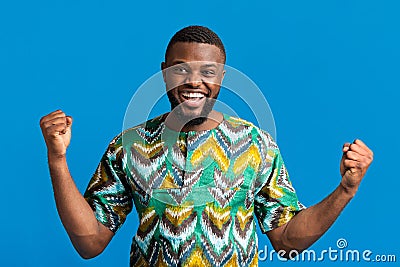 Emotional black man in colorful shirt expressing happiness Stock Photo