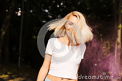 Emotional blonde woman in white t shirt with hair in wind posin Stock Photo