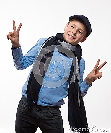 Emotional brunette boy in a cap and scarf Stock Photo