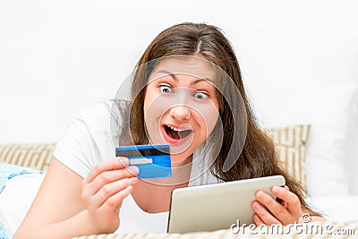 Emotional brunette with credit card Stock Photo