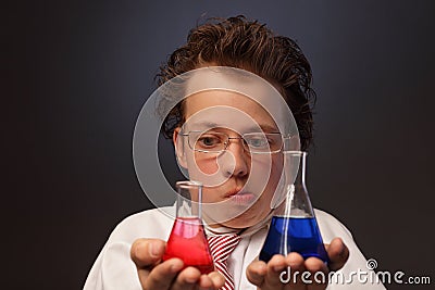 Emotional chemist with two flasks Stock Photo