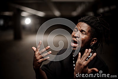 Emotional close up portrait of gesticulating afro american guy Stock Photo