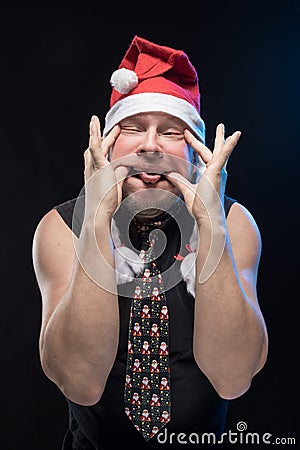 Emotional Comic actor man in cap with braids gesticulates, in anticipation of Christmas and New Year Stock Photo