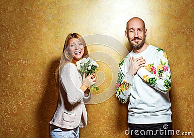 Emotional fashion couple give each other flowers on Valentine`s Stock Photo