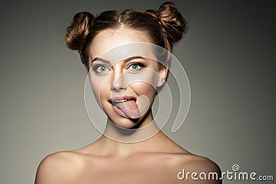 Emotional girl. Beautiful modern model shows tongue Positive woman hipster. Emotions on face. Stock Photo