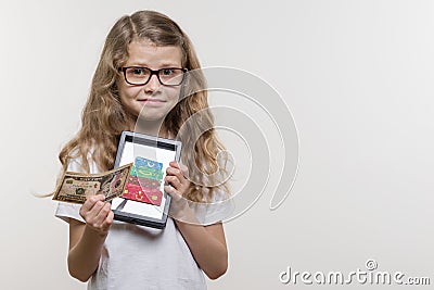 Emotional girl holding money and a frame with a picture of heap of suitcases, white background. Stock Photo