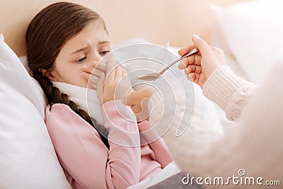 Emotional girl rejecting to drink a disgusting mixture Stock Photo