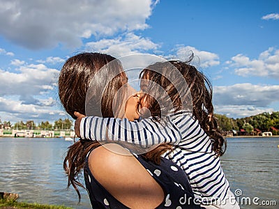 Emotional photo of a four-year-old girl . beautiful young mother with a child in nature. Stock Photo