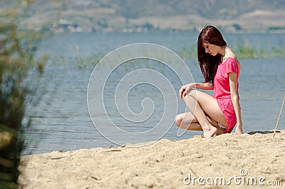 Emotional picture of a cute lady by a lake Stock Photo