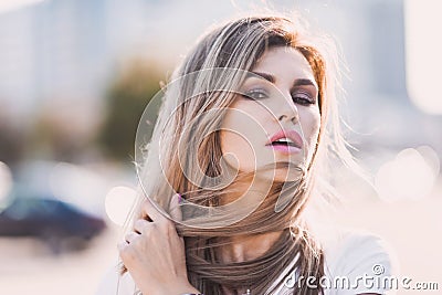 Portrait of Fashion stylish of young hipster blonde woman, elegant lady, bright colors dress, cool girl. City view urban l Stock Photo