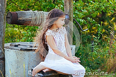 Emotional portrait of a little girl with long hair, summer day Stock Photo