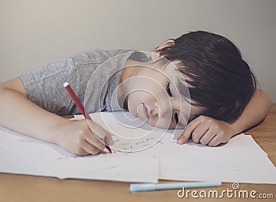 Emotional portrait of lonely child writing a messages to his mother, Preschool kid using red colour writing and drawing on white Stock Photo