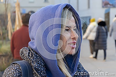 Emotional portrait of a 40-45 year old woman with long dyed hooded hair, emotion of bewilderment or outrage. Stock Photo