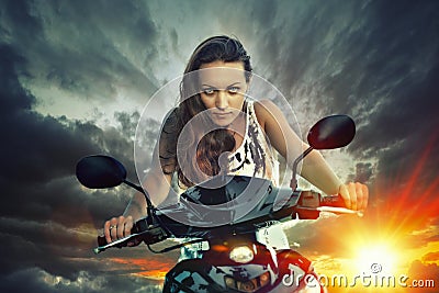 Emotional portrait of young beautiful woman on a motorbike on th Stock Photo