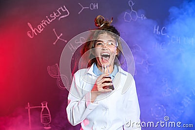 Emotional pupil holding conical flask in smoke with chemistry formulas Stock Photo