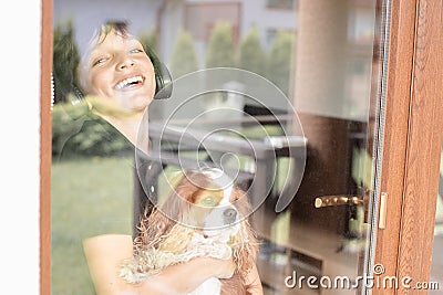 Emotional, satisfied, laughing and delightful teenager with coker spaniel dog Cavalier King Charles listening to music Stock Photo