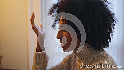 Emotional woman talking home close up. Curly hair positive lady gesturing hand Stock Photo