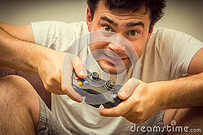 Emotional young addicted man playing video games Stock Photo