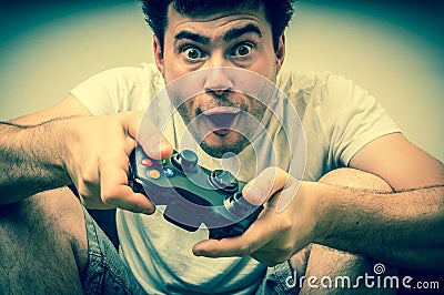 Emotional young addicted man playing video games Stock Photo