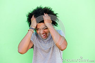 Emotional young man with hands in hair Stock Photo