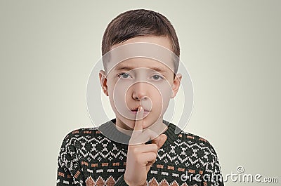 Emotions. The boy have a secret. Holding his finger up. Stock Photo