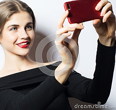 Emotions, expressions and people concept - happy smiling young woman wearing black dress taking selfie with smartphone Stock Photo