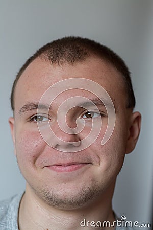 Emotions. The teenager smiles, expressing happy emotions on his face. Stock Photo