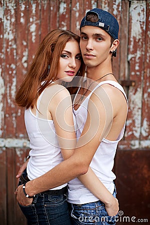 Emotive portrait of a stylish couple in jeans standing together Stock Photo