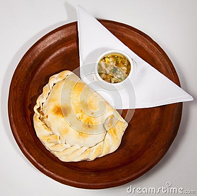 Chilean empanada accompanied by pebre sauce Stock Photo