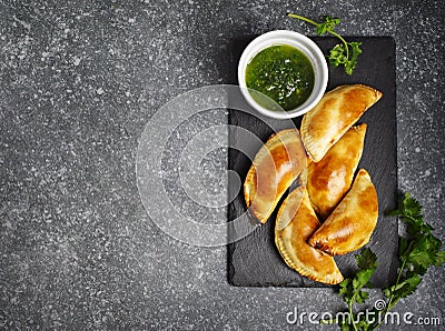 Empanadas with chimichurri sauce. Latin American tradition cuisine Stock Photo